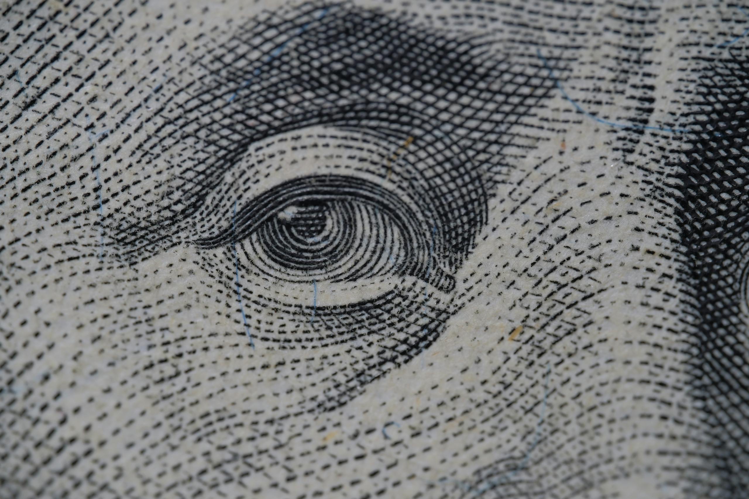 Detailed close-up of an illustration from a dollar bill, focusing on intricate line work.